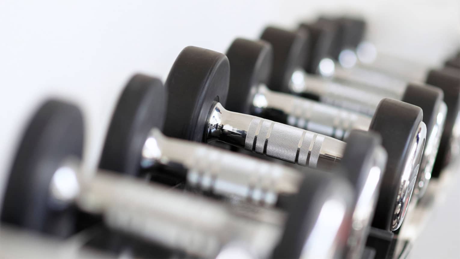 Close-up of hand weights in row on rack in Fitness Centre