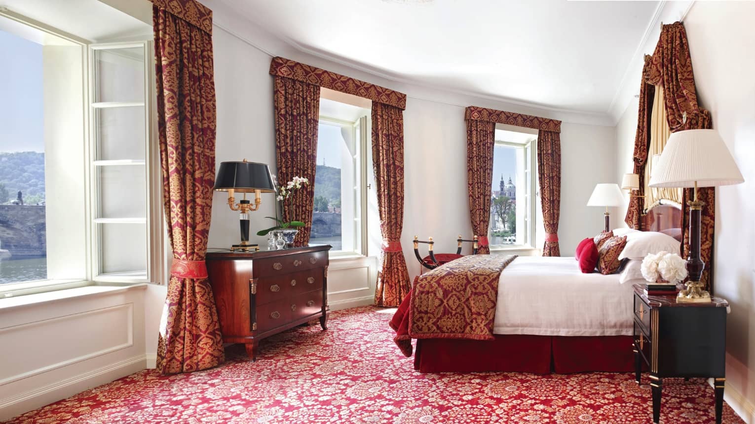 Presidential Suite with bright windows along curved wall, Baroque-inspired red-and-gold carpet, curtains