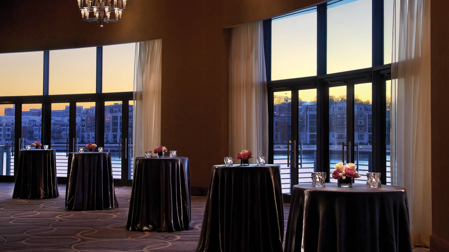 Sunset views by cocktail tables in Grand Ballroom pre function space 