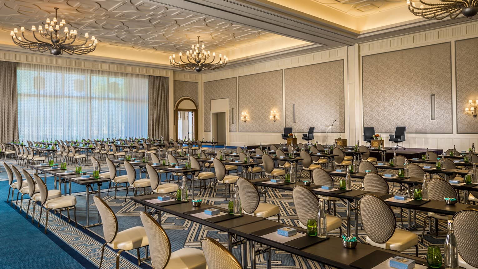 Rows of chairs, meeting tables in large Dana ballroom event space with high ceilings, chandeliers