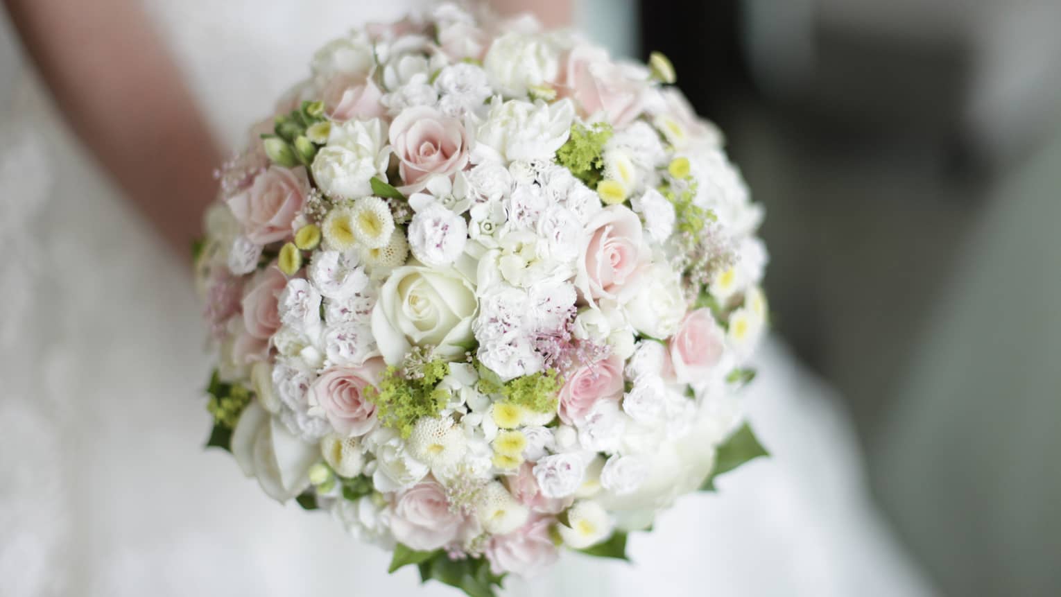 Round floral wedding bouquet with small white and pink roses 