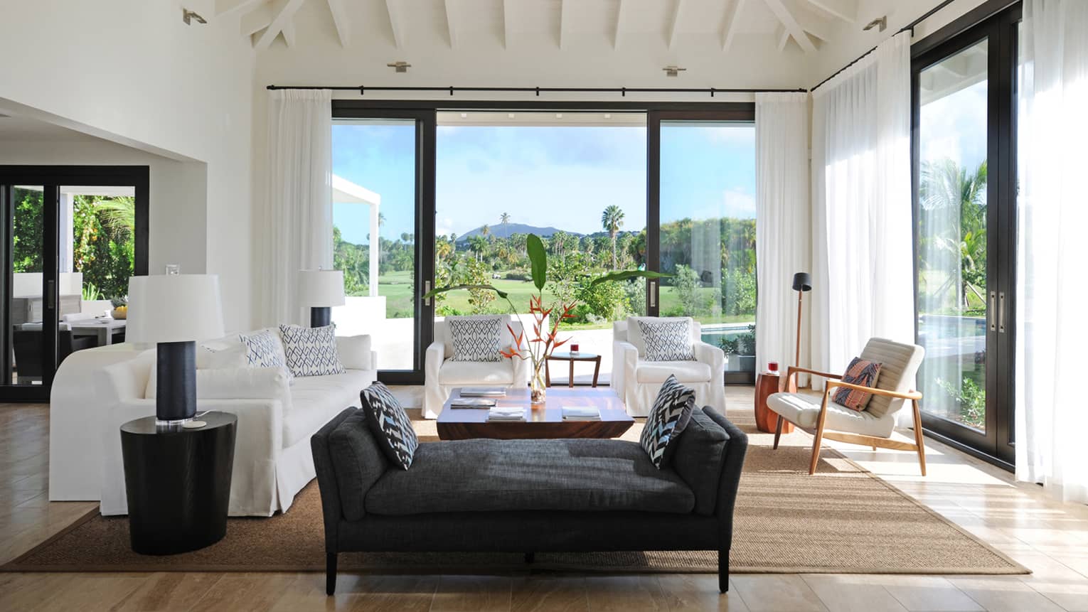 Pinney's Beach Residence Villa black chaise, white sofas, large glass patio door