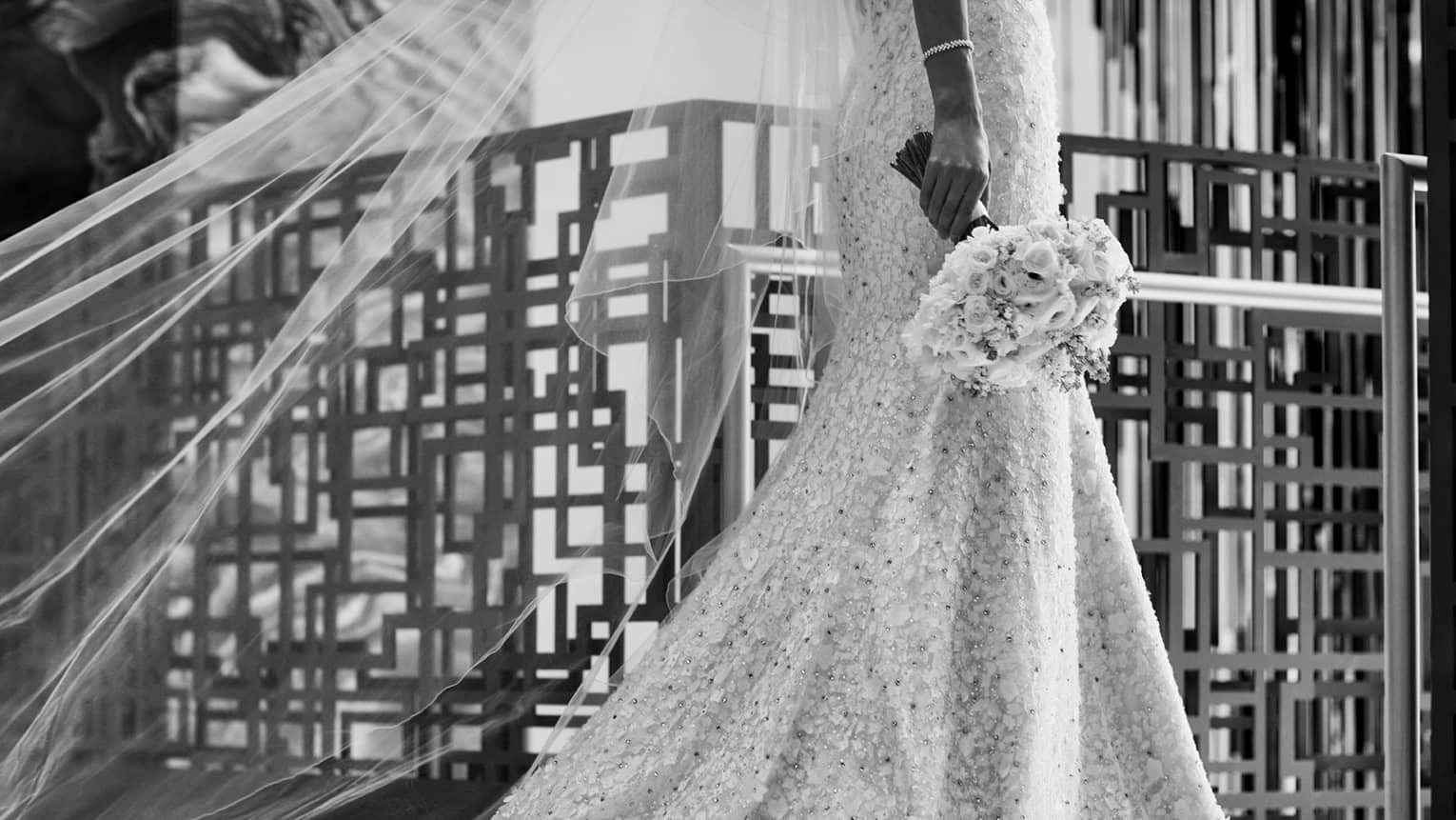 black and white photograph of a bride holding a bouquet