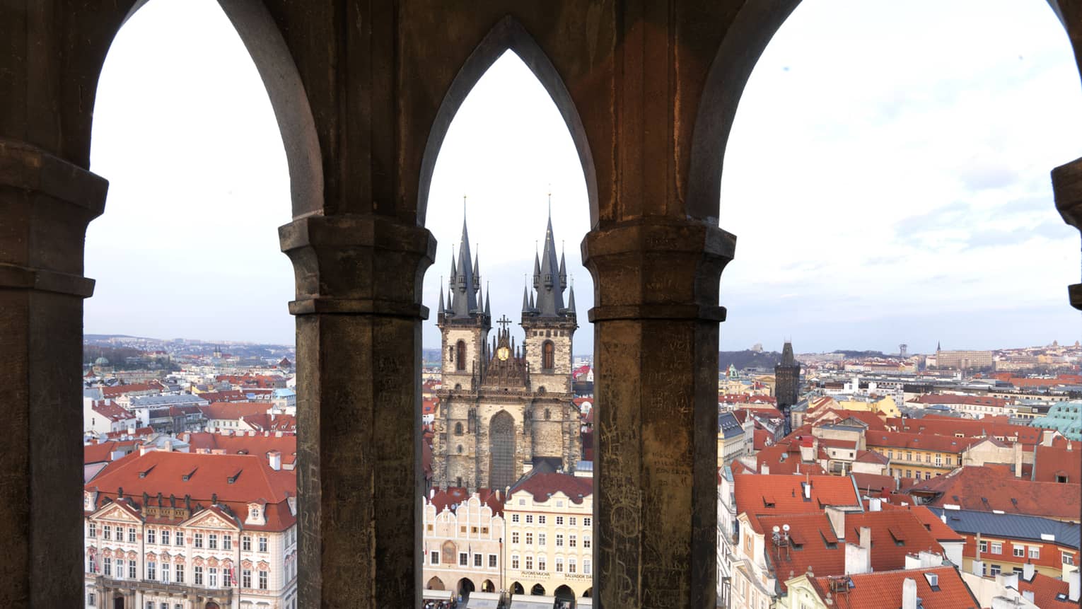 Old Town Prague, view past historic posts over city rooftops