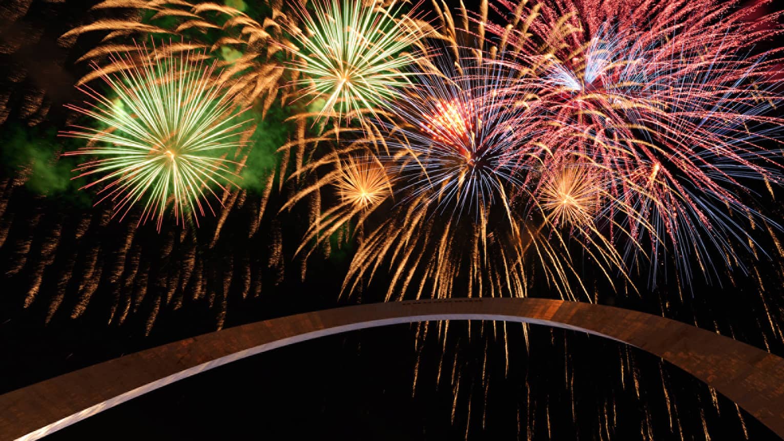 Colourful fireworks light up a night sky over Gateway Arch