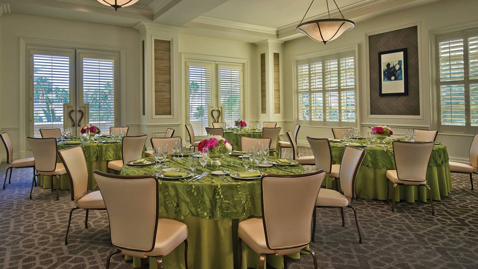 Mesquite Room with small round dining tables with green linens 