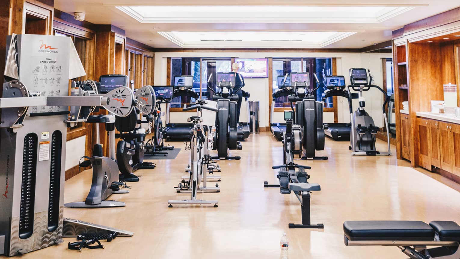 A spacious indoor fitness center filled with various exercise equipment