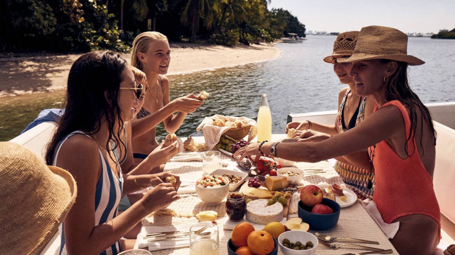 A group of women eating on a boat.