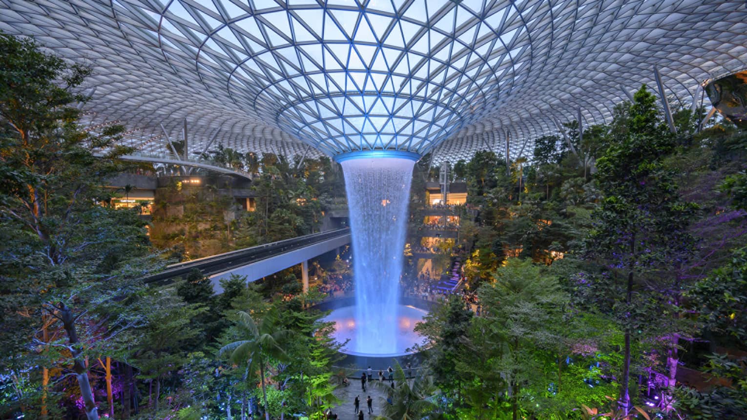 An arial view of an indoor garden with a large fountain in the center in singapore