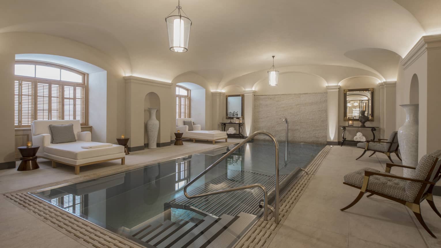 AVA Spa vitality pool  flanked by white lounge chairs under domed ceiling