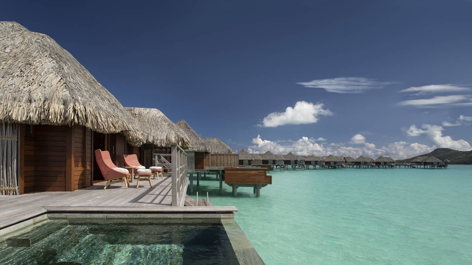 View of plunge pool and clear-blue lagoon from the deck of Two Bedroom Water Bungalow