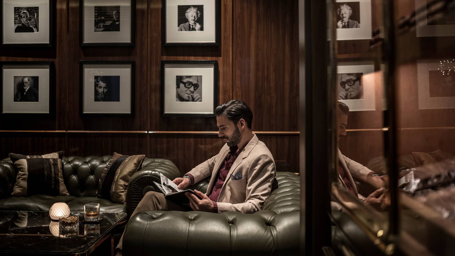 man reading on sofa in luxury hotel