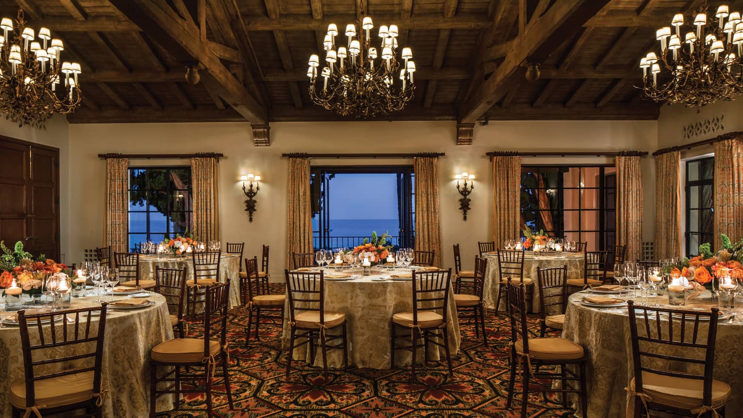 El Mar ballroom with round banquet tables under chandeliers, open patio doors