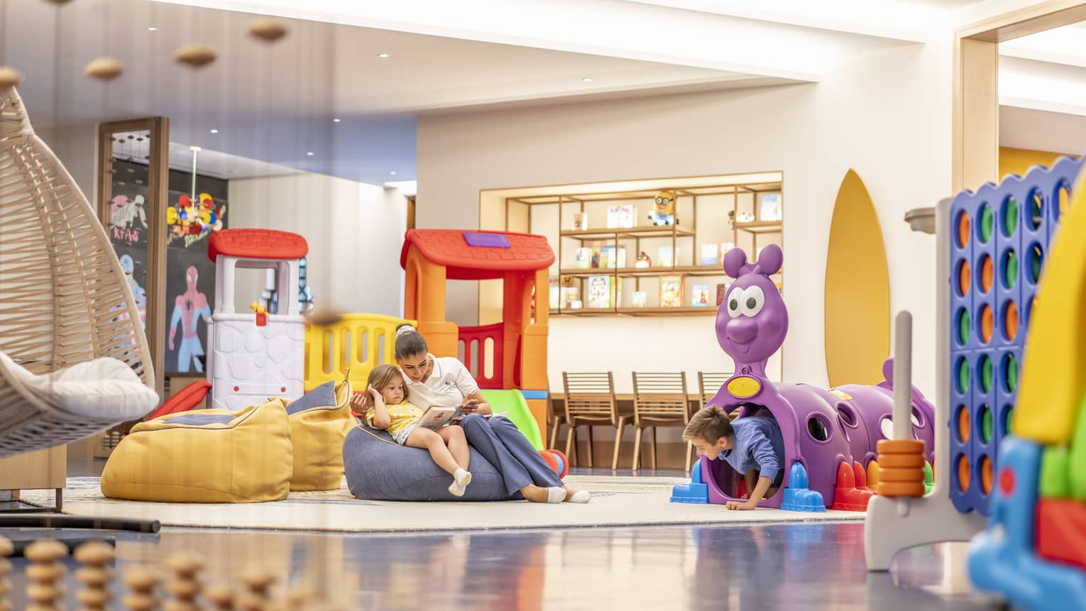 Kids playroom with colourful toys and bean-bag chairs