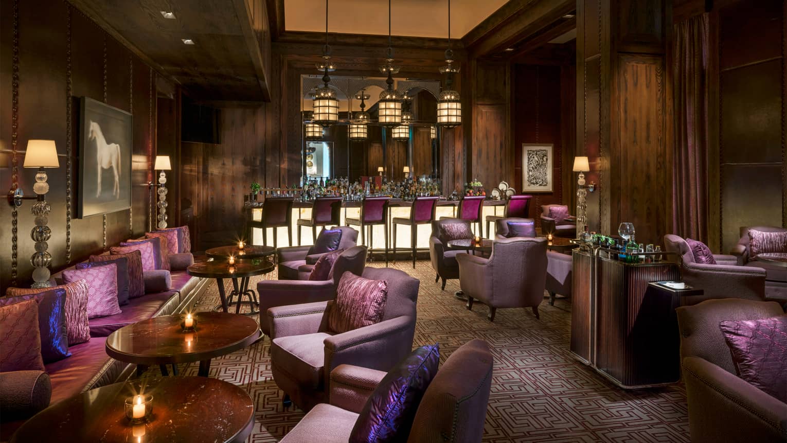 Hendricks Bar dimly-lit cigar club lounge with rich wood and purple decor