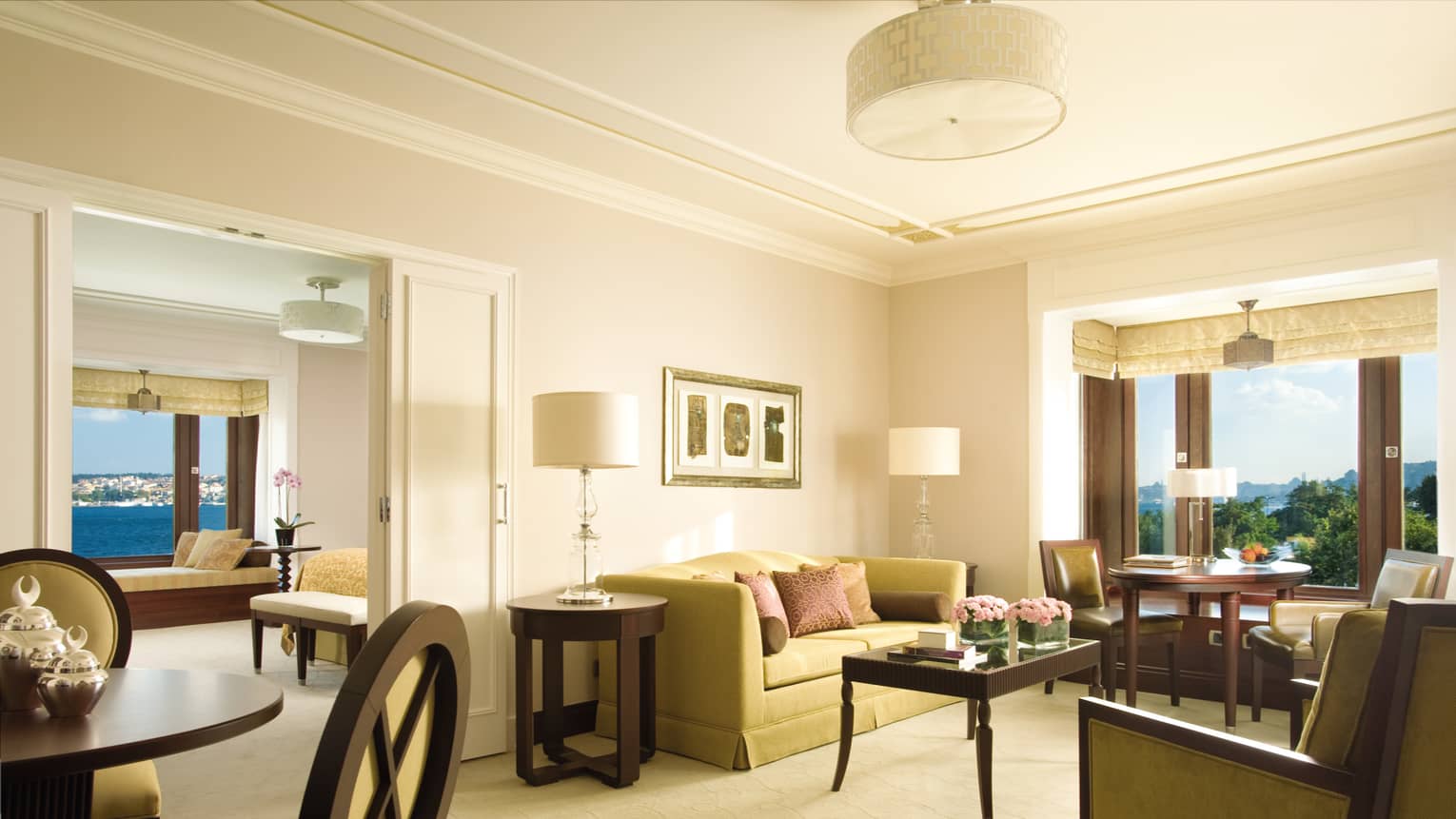 Bosphorus Suite seating area, small round dining table in front of bay windows, bedroom doors