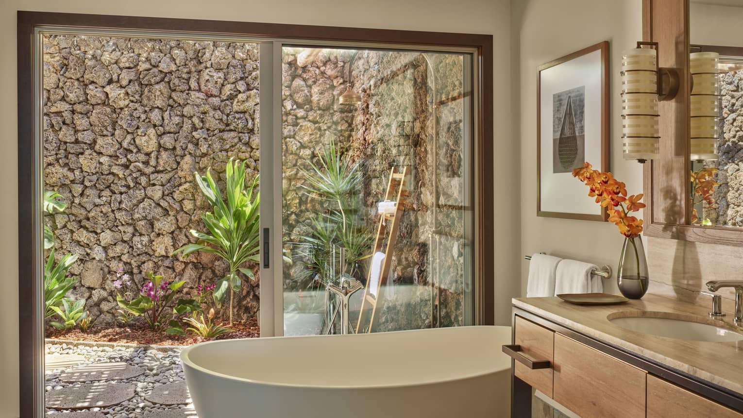Bathroom with freestanding tub, walk-out outdoor shower