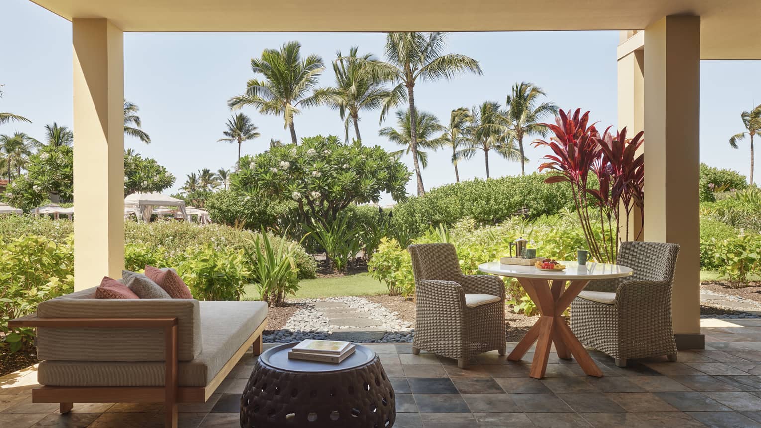 Outdoor covered terrace with tile floor, palm tree landscaping