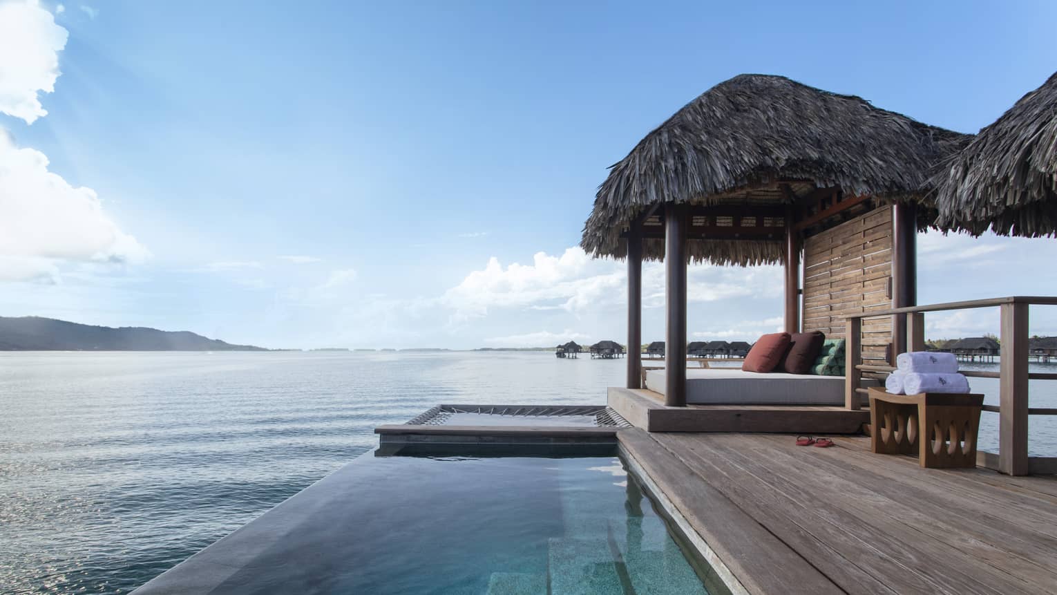Private deck of Bungalow, with infinity pool and thatched-roof sun bed