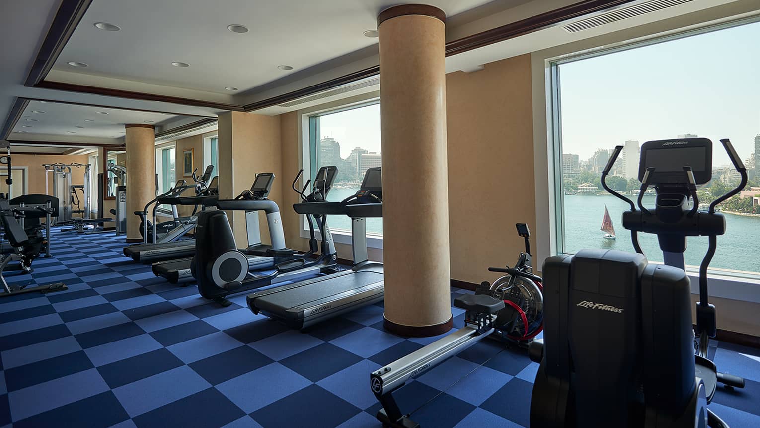 Row of cardio machines in front of window overlooking Nile river