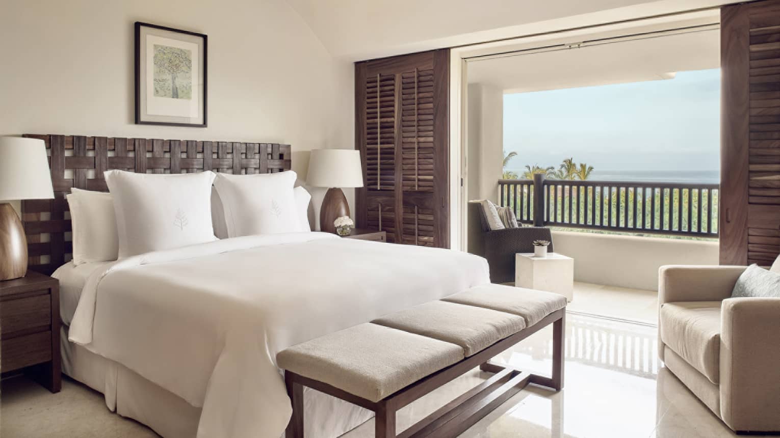Bedroom with king bed, wooden shutter sliding doors and ocean view