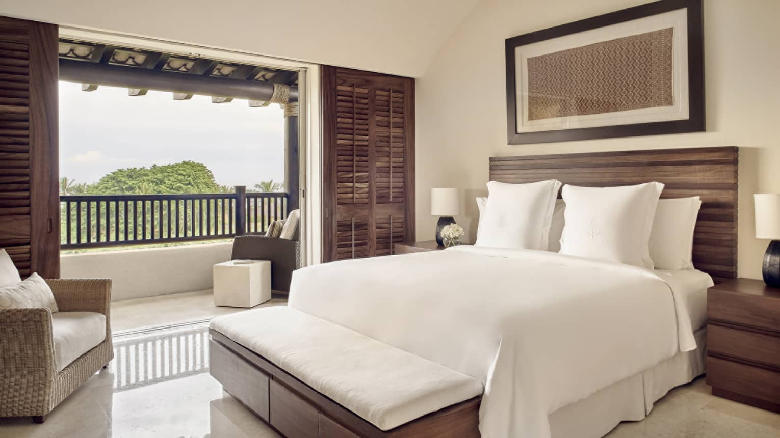 Bedroom with king bed, wooden headboard, balcony