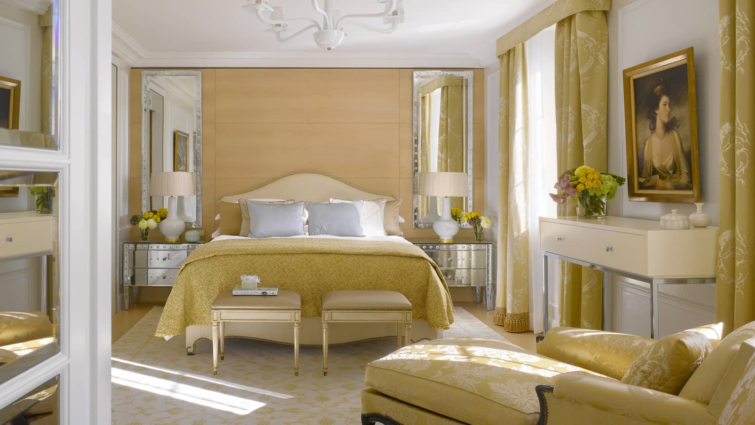 Presidential suite with queen bed, chaise lounge, and gold Victorian accents