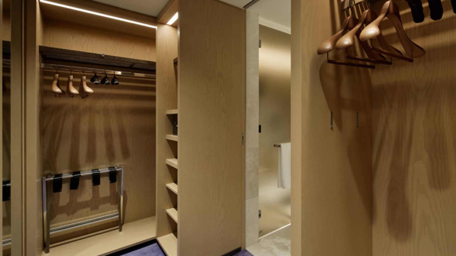 Walk-in closet with wooden shelves and purple carpeting