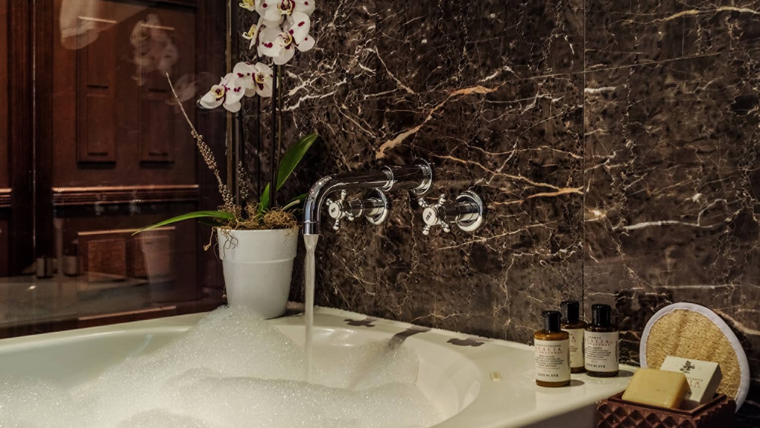 Black marble bath tub with bubbles
