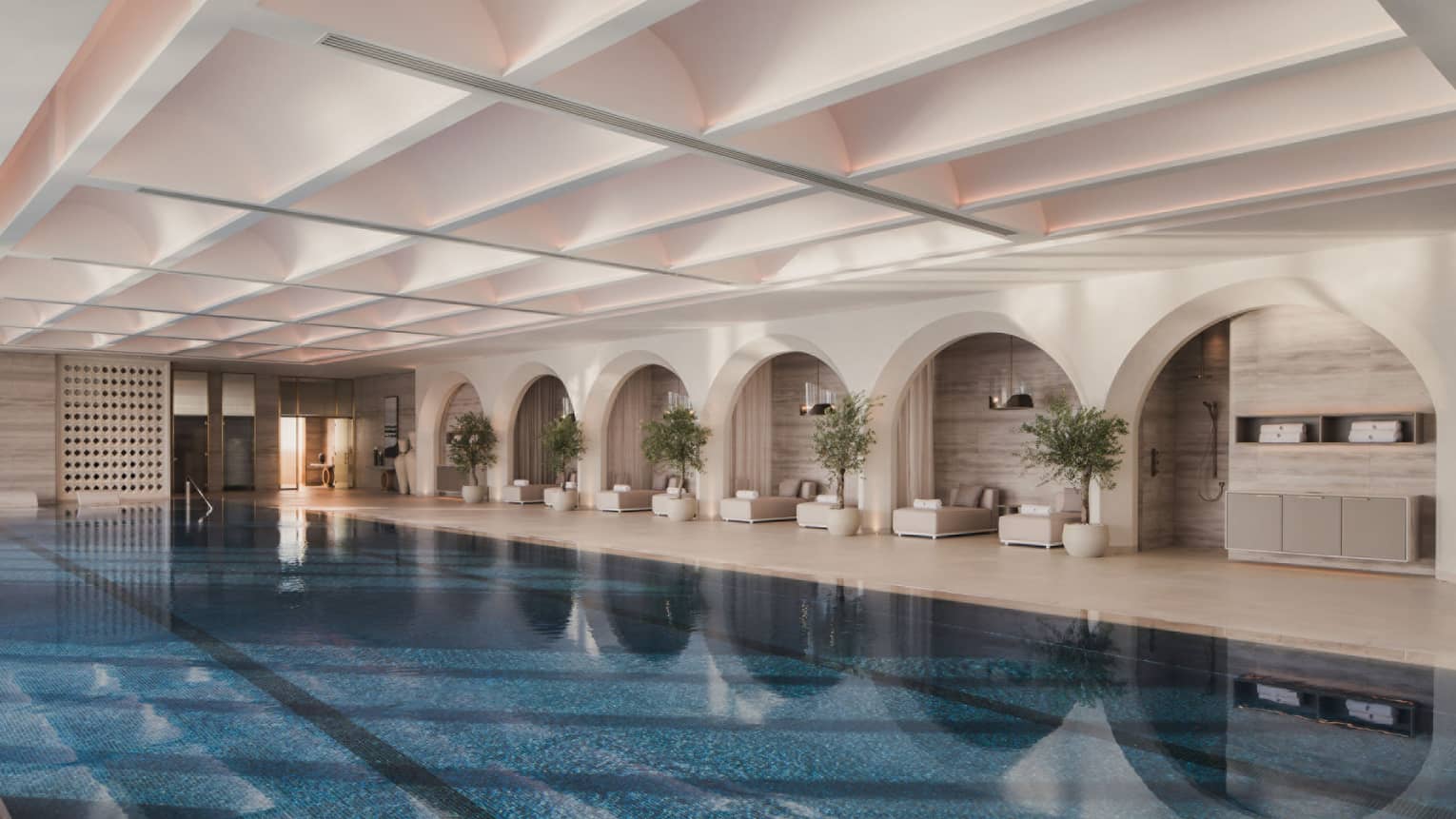 Large indoor swimming pool with pool lounge chairs