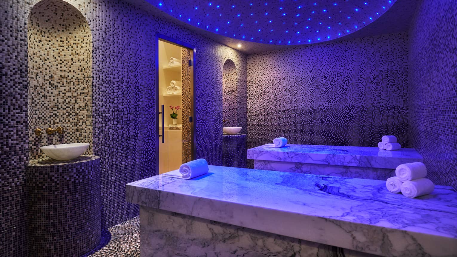 Two marble beds in private Hammam spa room with tiles, dome ceiling with small blue lights