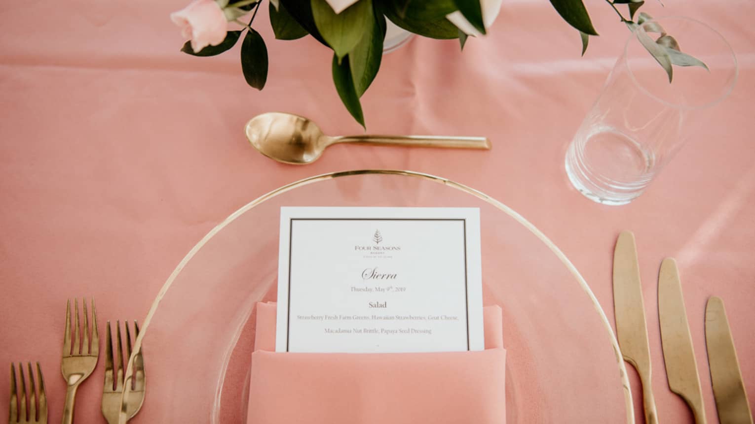 Pink wedding table setting with gold flatware, elegant place card and pink bouquet