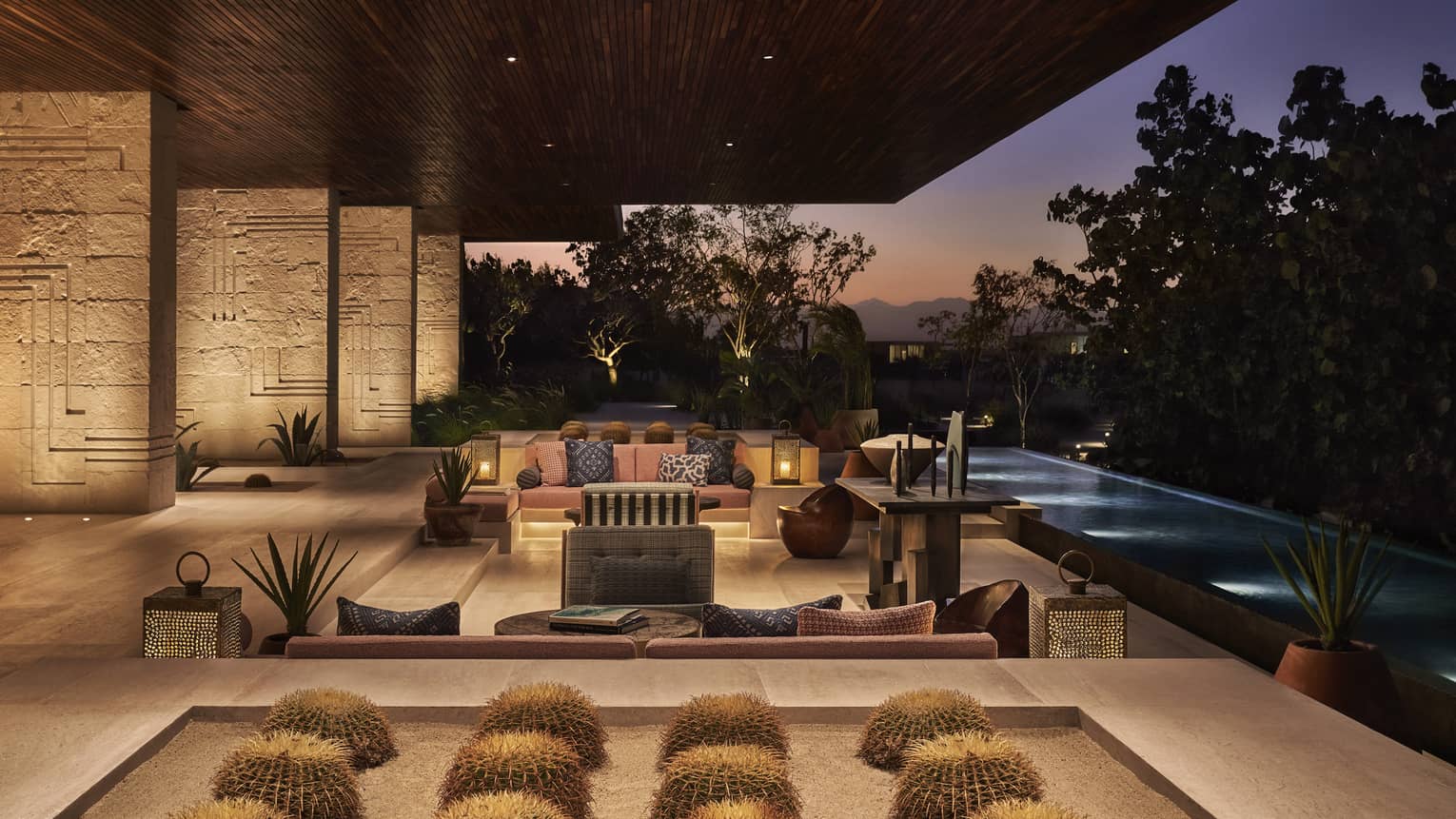 Open air lobby with cactus display, modern patio sofas at dusk