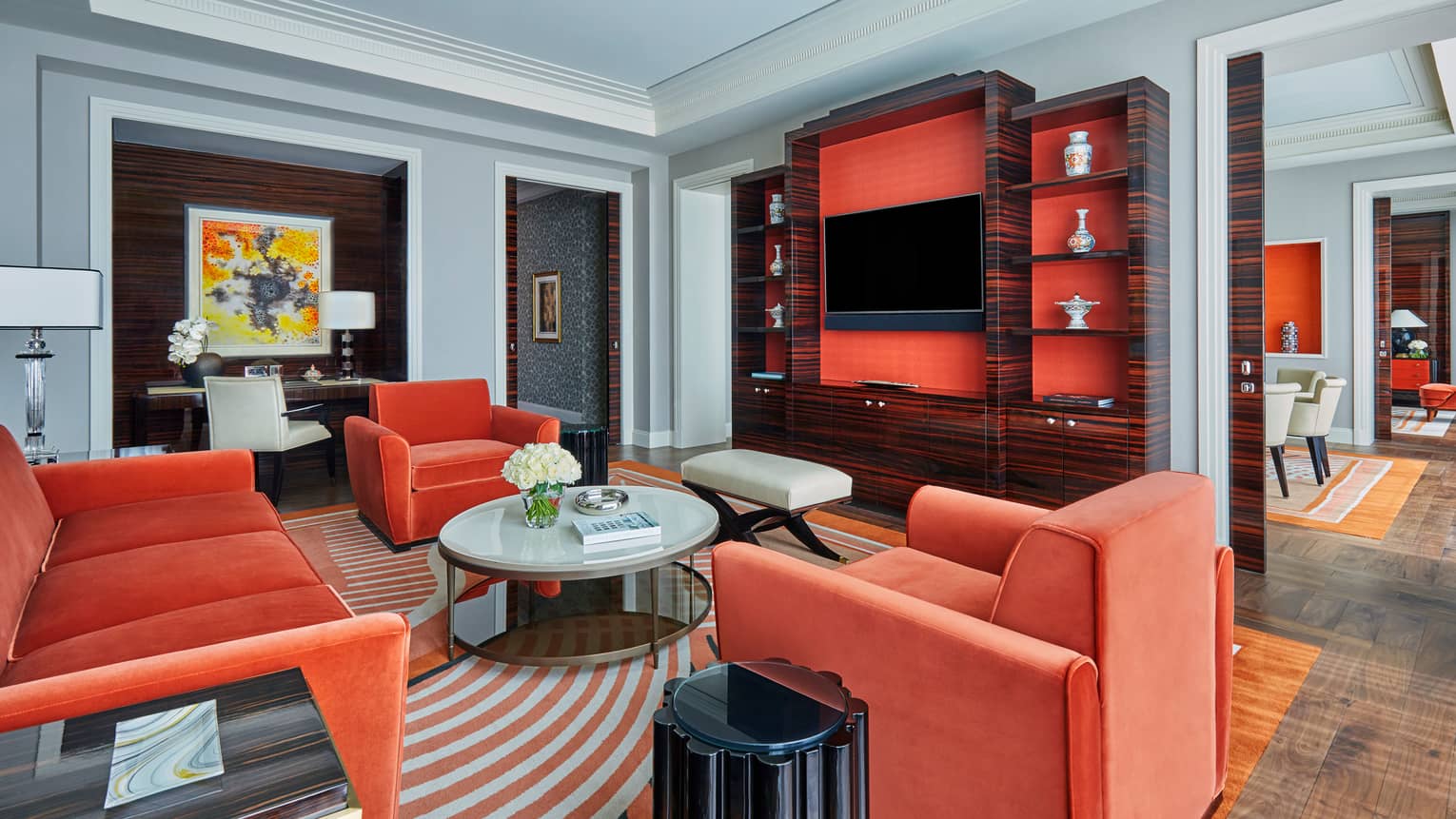 State Suite with warm orange velvet sofa and chairs, round coffee table, TV cabinet