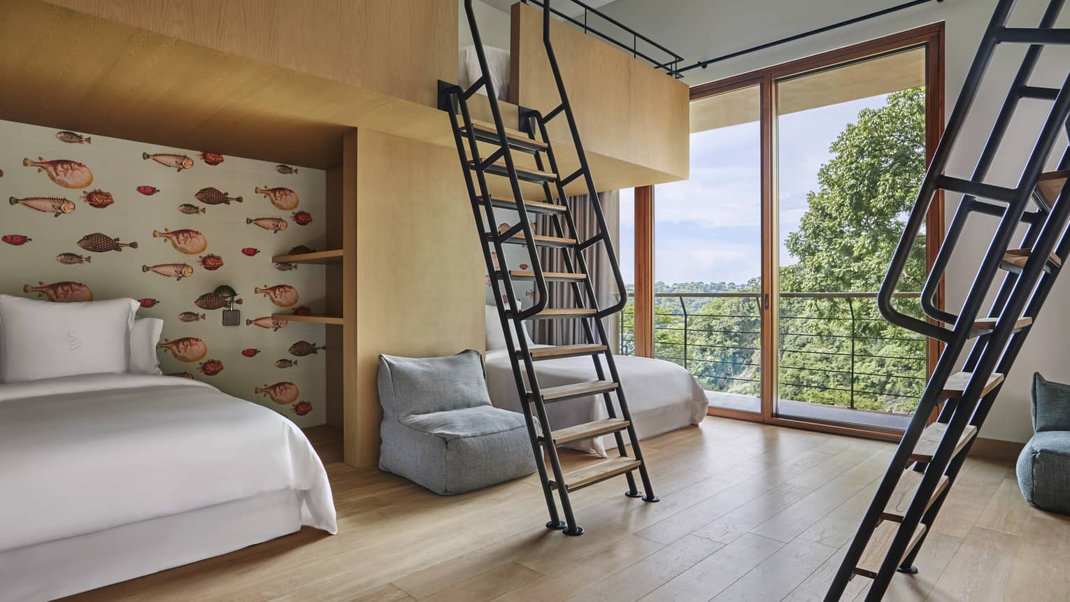 Bedroom with twin beds on the ground floor, and two ladders lead up to built-in bunk beds