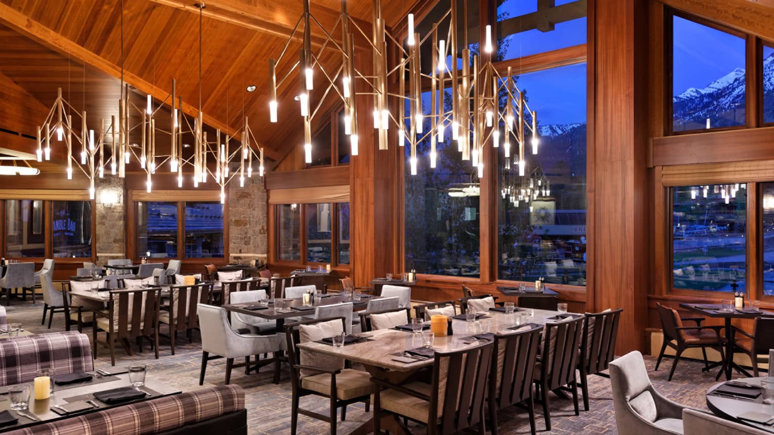 Empty dining room, wooden ceiling and exposed beams, bright chandeliers