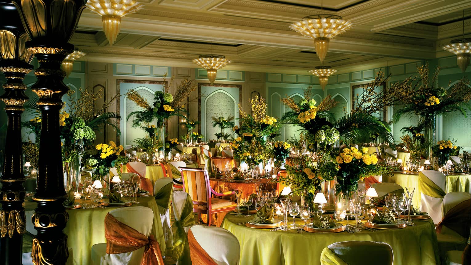 Gala dinner in Al Mirgab Ballroom with linen covered banquet tables and chairs, large floral arrangements 