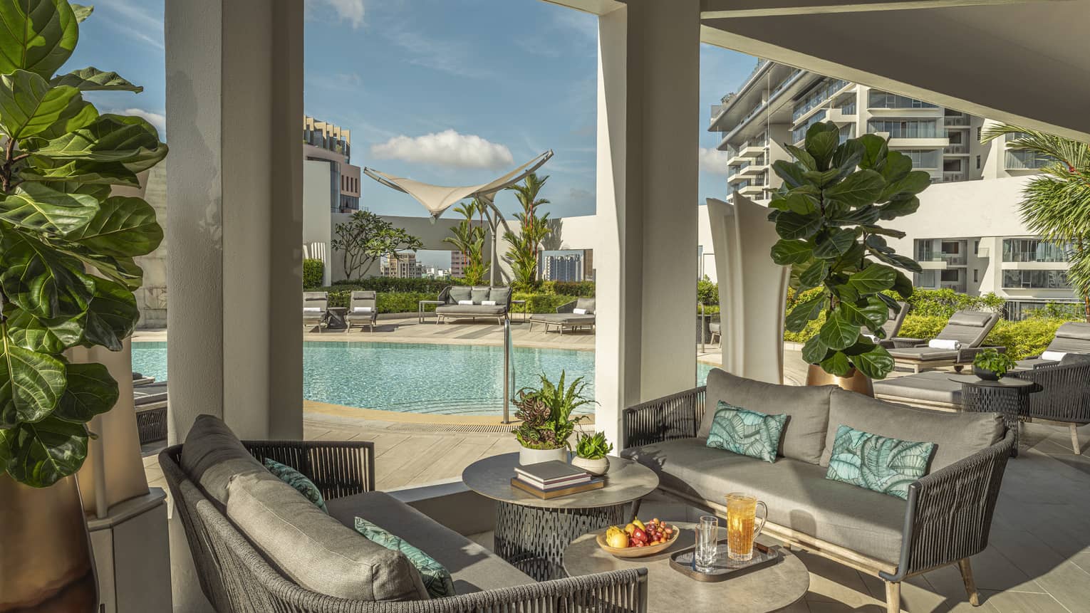 View of 20th-floor from outdoor lounge with grey poolside furniture