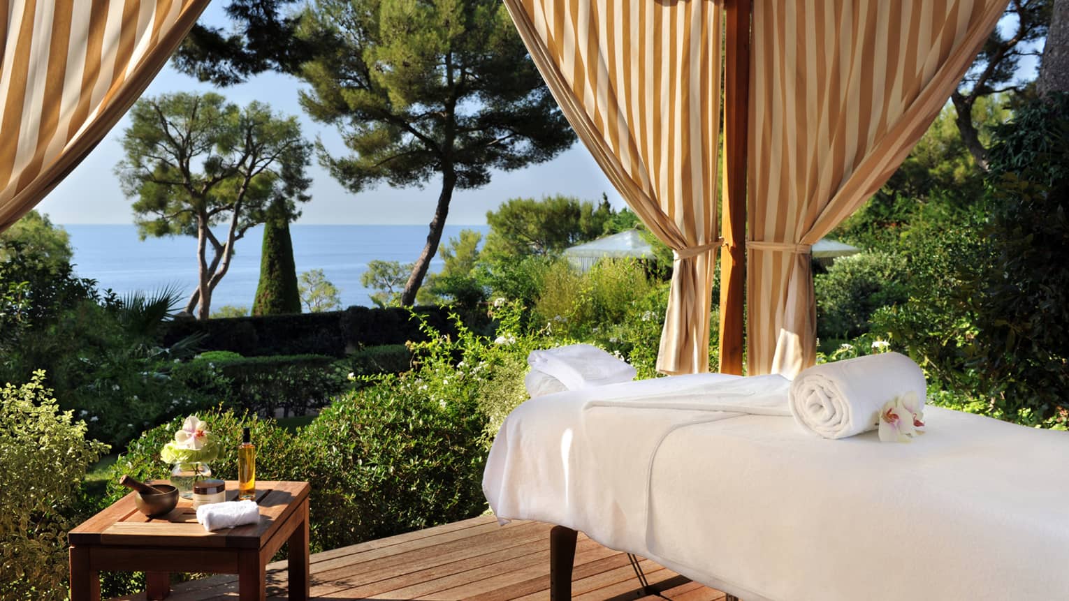 Massage bed on outdoor Spa pavilion overlooking gardens, sea