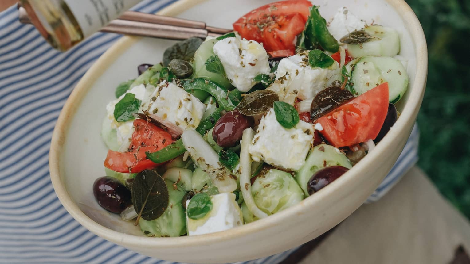 Greek Salad with Feta Cubes, Tomato Wedges, Cucumber Rounds, Onion Slices and Black and Kalamata Olives