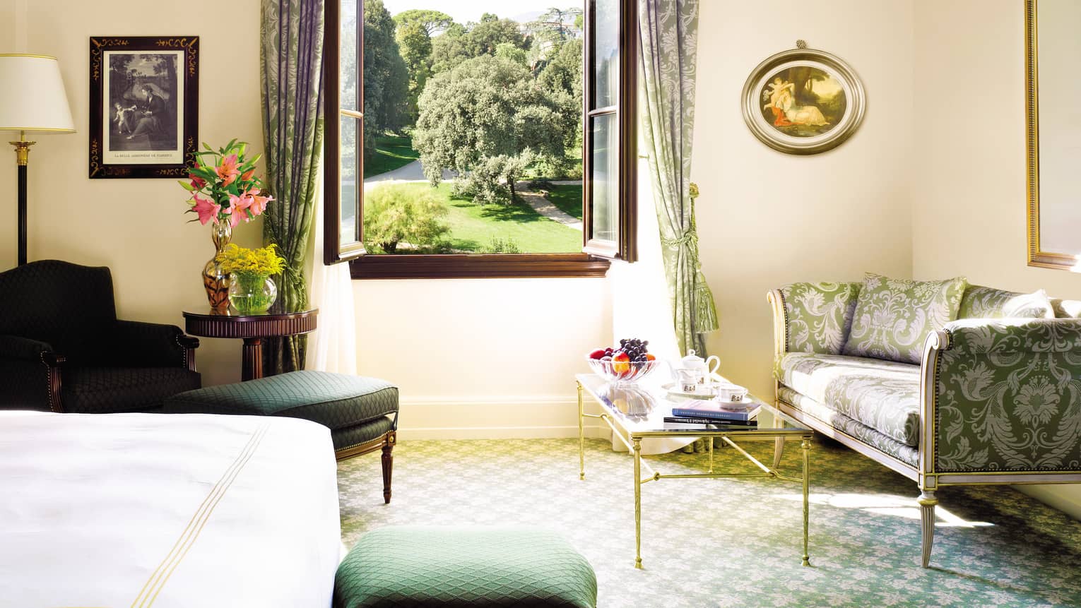 Four Seasons Room silk sofa, armchair, table under large open window overlooking gardens