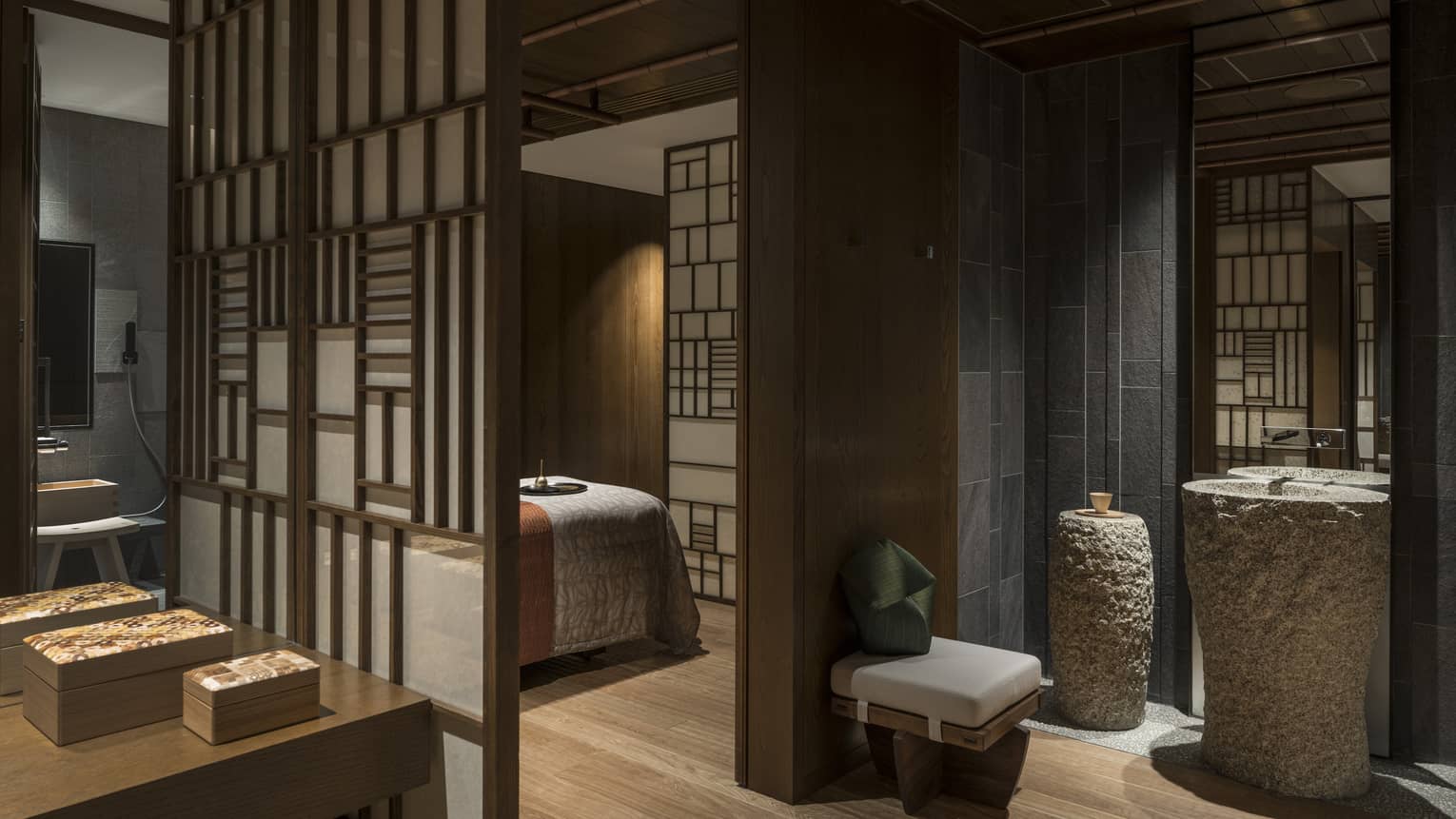 Spa treatment rooms behind screens, large stone vases