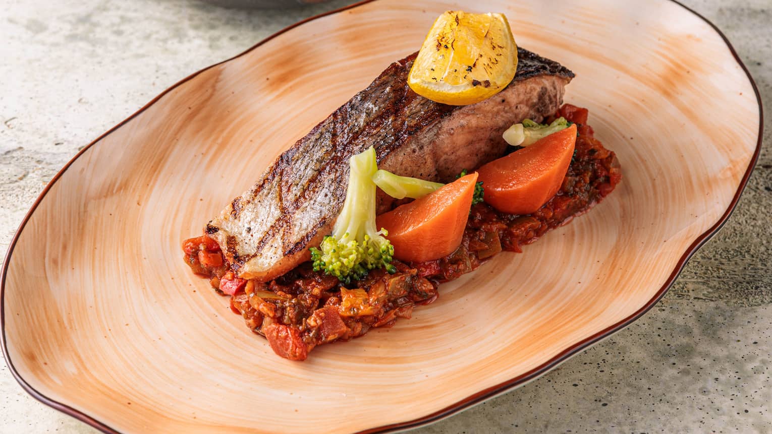 Fish on a pastel orange plate.