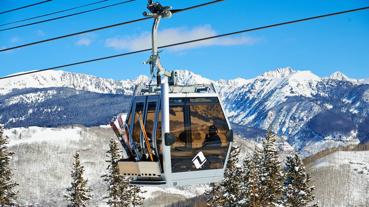 Ski lift heads uphill on snowy Vail, Colorado mountain