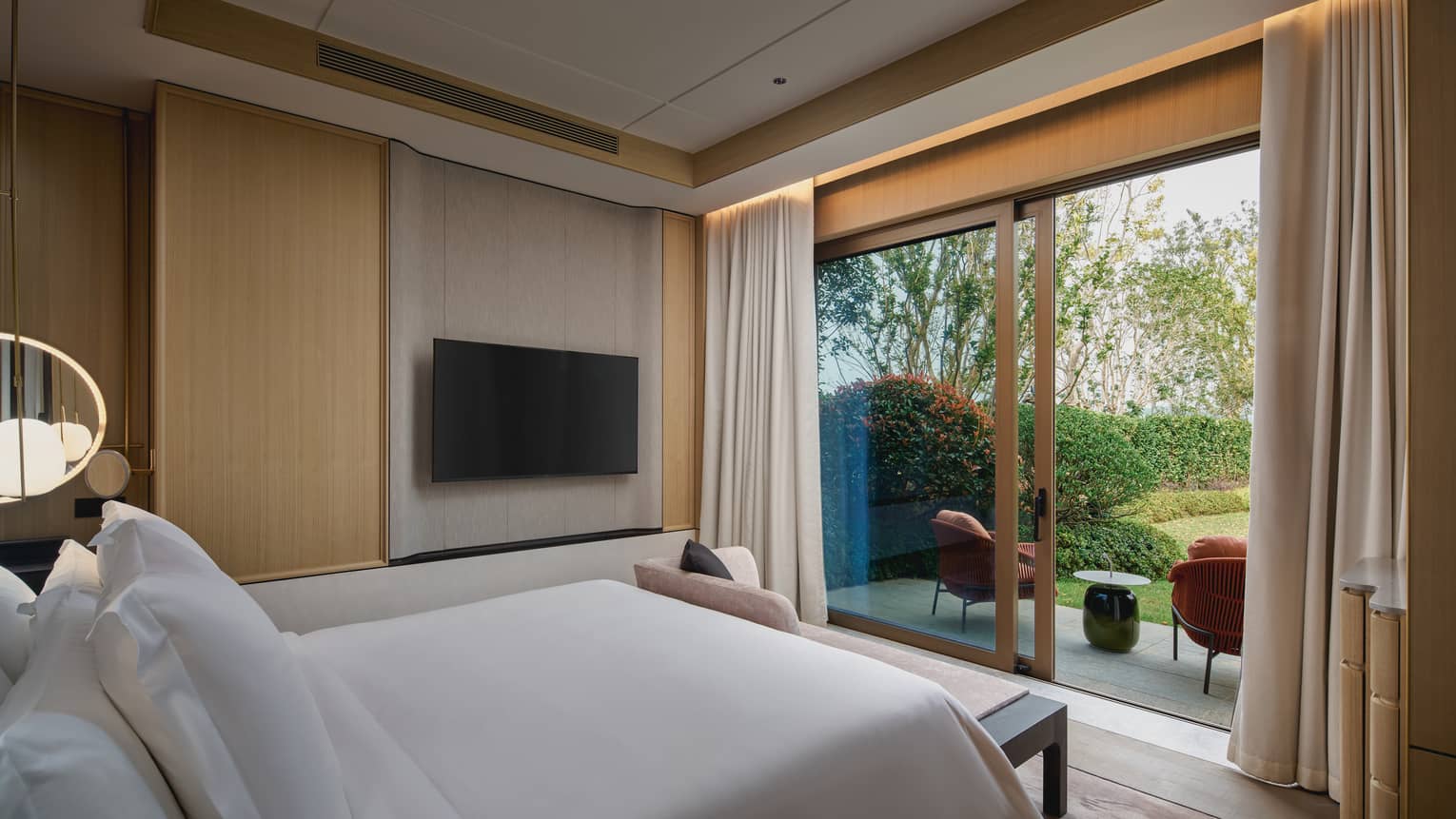 Villa bedroom with walk-out garden view at Four Seasons Hotel Suzhou