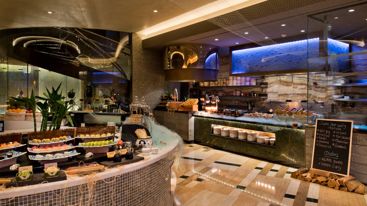 Bahrain Bay Kitchen buffet stations with sushi and seafood bar, sushi rolls on white platters 