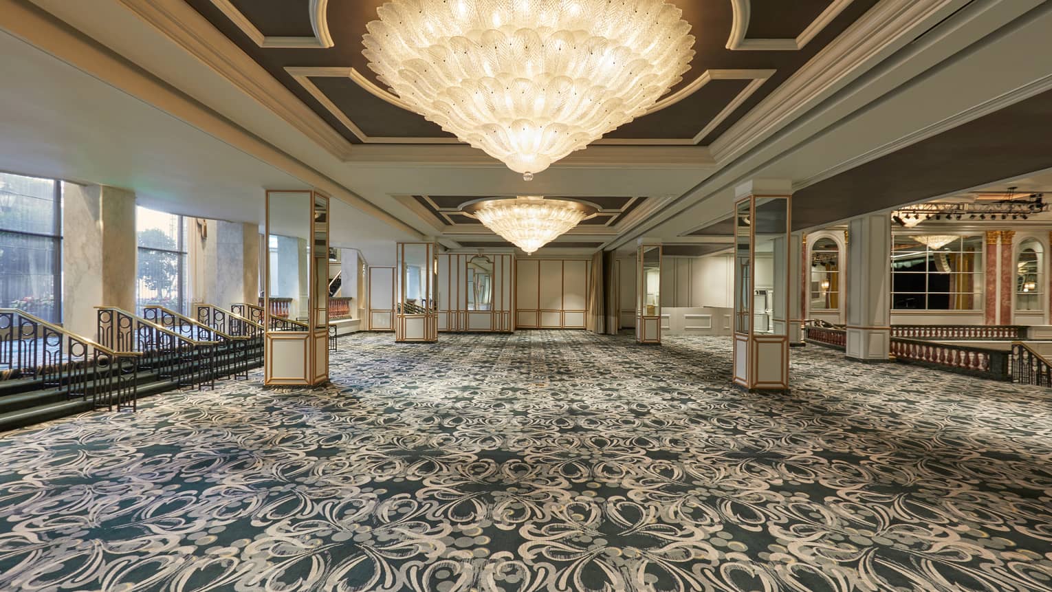 Winter Garden ballroom carpeted event space with large cone shaped crystal chandeliers 