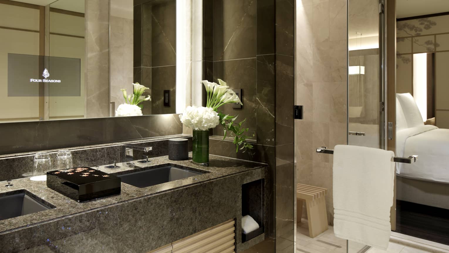 Bathroom with two sinks and glass shower