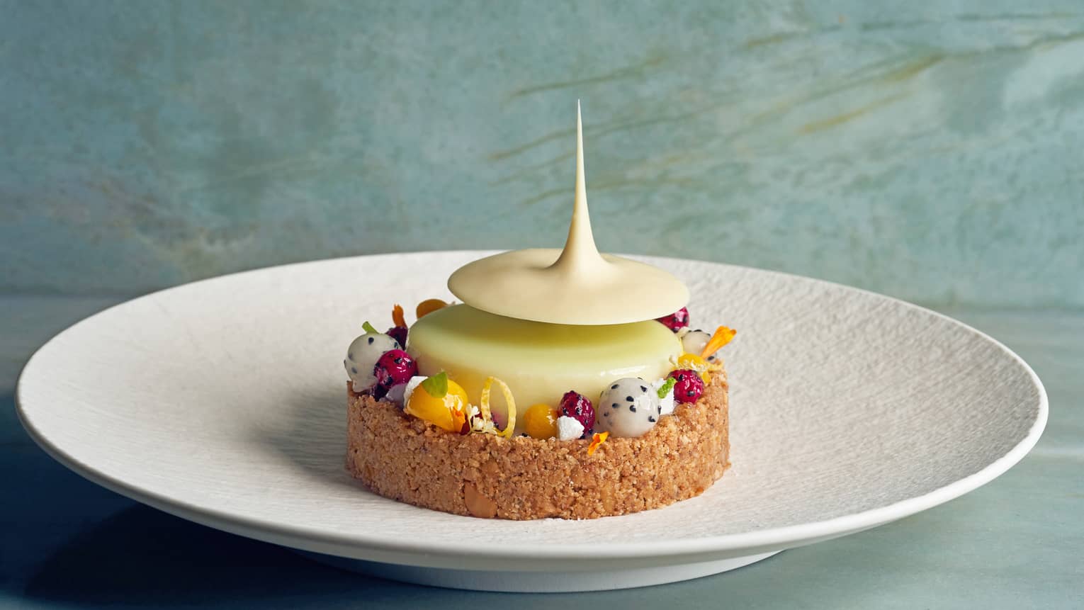 Key lime dessert with balls of dragon fruit and mango, and a macadamia nut–coconut crust