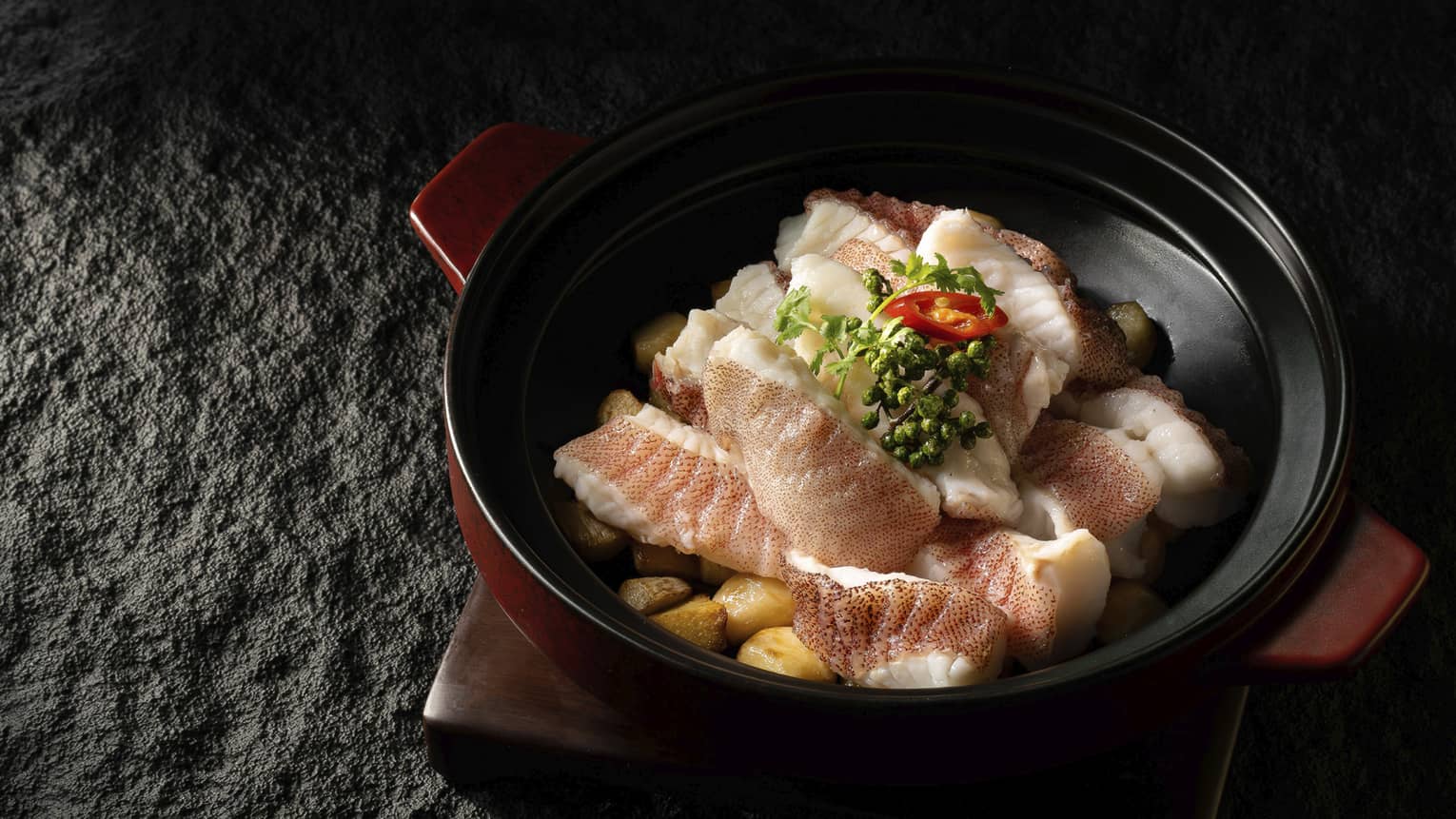 Star grouper in clay pot with fresh green peppercorns